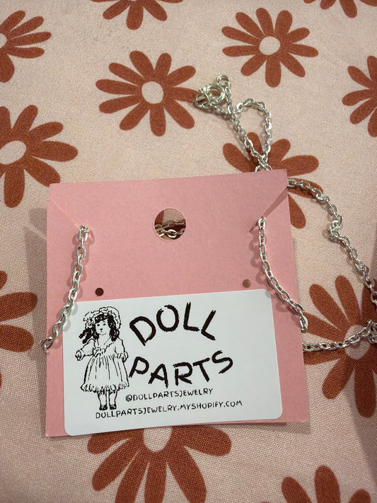 Doll hand necklace