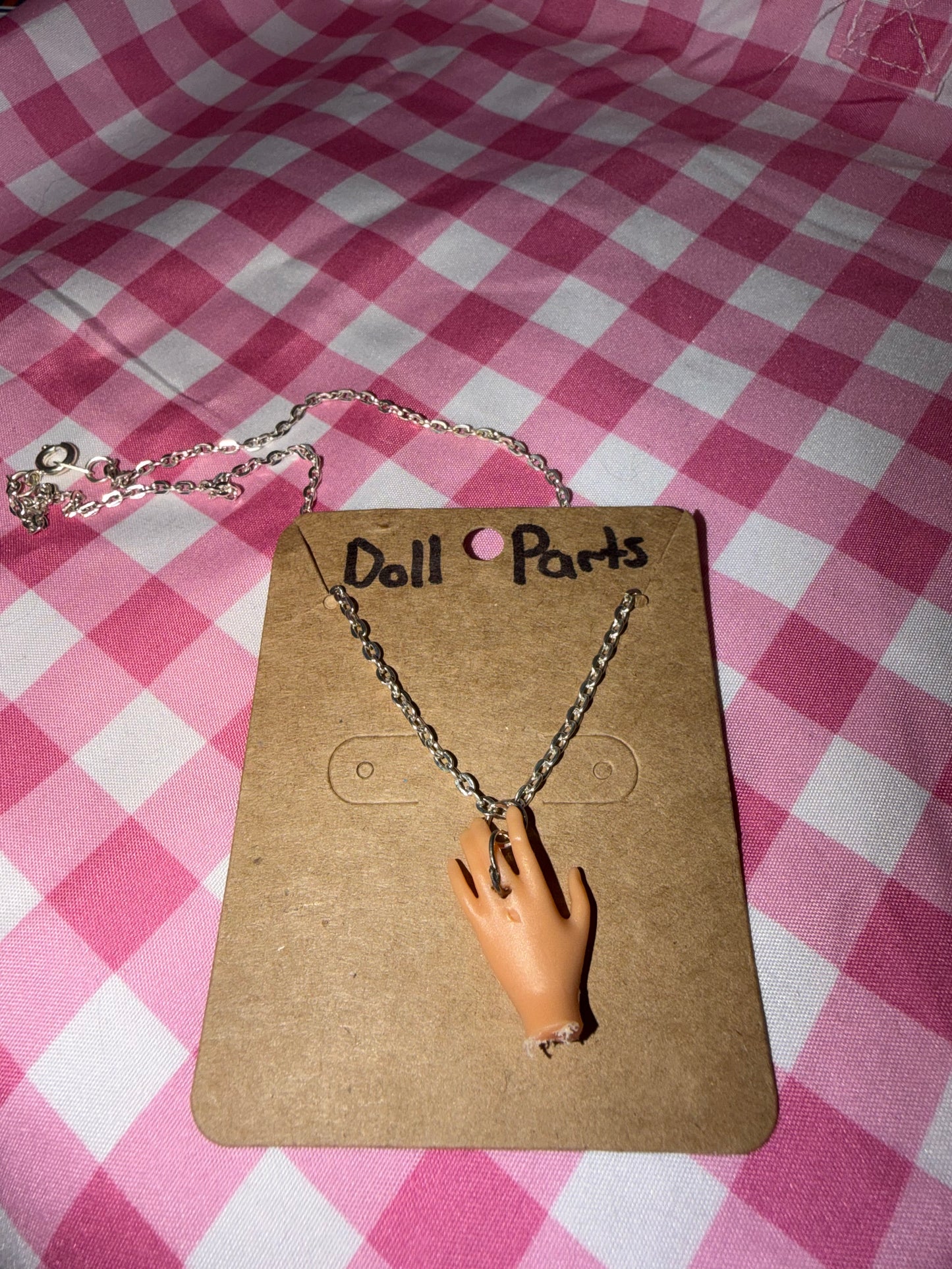Doll hand necklace